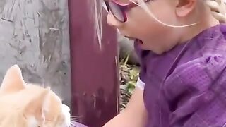 Mother cat introduces her children to her human friend