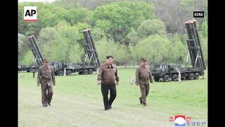 North Korean state media shows Kim Jong Un watching rocket launches.