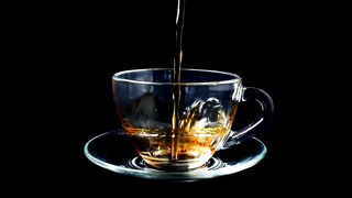 Pouring tea into a glass cup -adalinetv