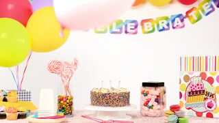 Birthday party table with balloons falling