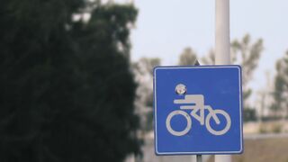 Cyclist sign next to a road, vertical shot - adalinetv