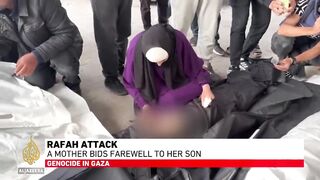 Rafah attack_ A mother bids farewell to her son.