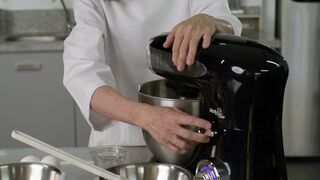Portrait of a pastry chef using a blender