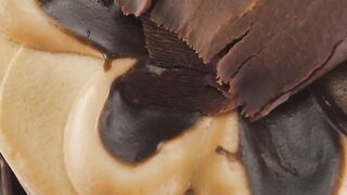 Slowly rotating chocolate cake seen from above