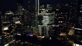 Reverse aerial shot of a city at night
