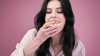 Girl eating a glazed donut with a milkshake