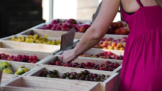 A woman choosing fruit at a market