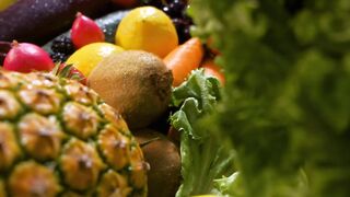 Surface covered with many fruits and vegetables seen in detail