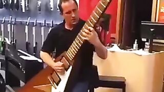 Guitarist playing a huge electric guitar