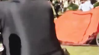 Emory's Caroline Fohlin is knocked down by the police while shouting: “I’m a professor!!