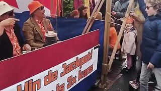 Dudes playing fruit machine on king's day