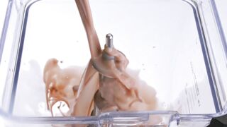 A continuous stream of chocolate milk fills a transparent blender