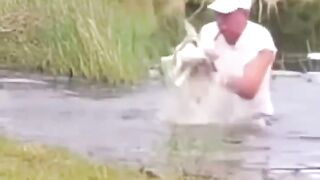 man saves his puppy from being eaten by an alligator