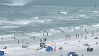 Footage captures waterspout ripping through crowded beach #Shorts