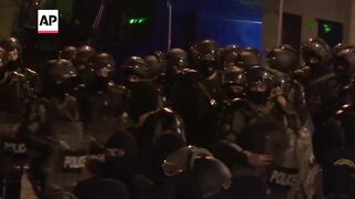 Police in Tbilisi disperse demonstrators outside Georgia's parliament.