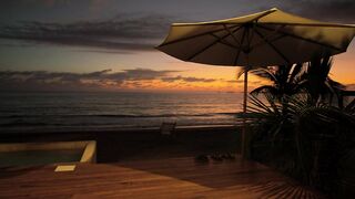 Sunset on a beach seen from a terrace - adalinetv