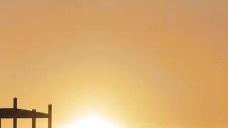 Sun hiding between hills on the horizon - adalinetv