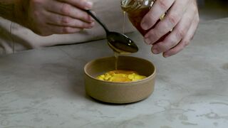 Pastry chef adding honey to a mixture