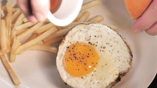Burger being prepared with french fries
