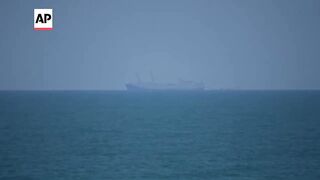US Navy ship, other vessels visible off Gaza's coast amid efforts to boost aid.