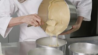 Woman pastry chef pouring a mixture into baking molds
