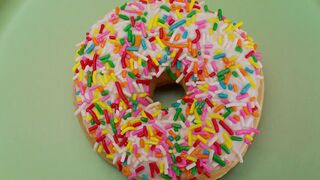 Colorful glazed donut rotating in a close up shot