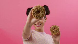 Girl playing with nutty donuts