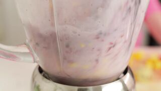 Blending a fruit smoothie in a blender