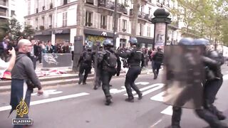 Paris marks Intl Workers' Day_ Main unions lead the march demanding better pay.
