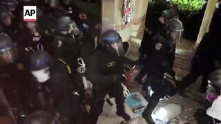 Police and protesters clash at UCLA in tense scene as pro-Palestinian encampment is dismantled.