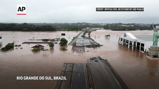 People rescued from rooftops in flood-stricken Brazilian state.