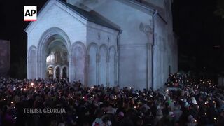 Georgian protesters against 'Russia-style' media law mark Orthodox Easter with candlelight vigil.