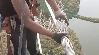 Electricity wires being manually wrapped for protection.Electricity wires being manually wrapped for protection.