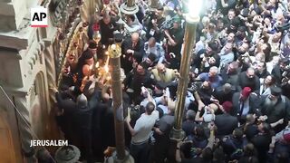 Eastern Orthodox worshippers throng Holy Fire ceremony in Jerusalem.