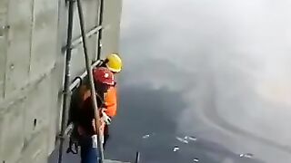 Scaffolders dismantling a hanging scaffold