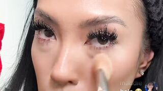 A black girl applying makeup