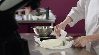 Professional pastry chef adding butter for a mixture