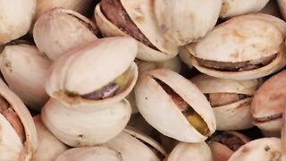 Piled up pistachios spinning seen up close