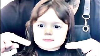 Little cute girl cutting her hair smile