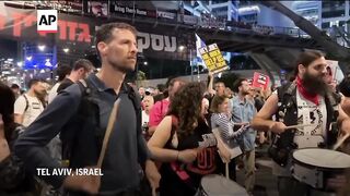 Demonstrators in Tel Aviv  on Israel to agree to hostage deal.