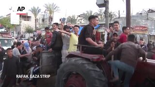 Palestinians celebrate in Rafah after Hamas accepts ceasefire proposal.