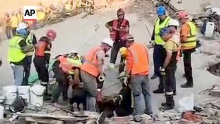 Rescuers search for missing dozens after building collapse in South Africa.