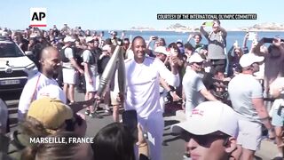 Ex-NBA star Tony Parker takes his turn in Olympic torch relay in Marseille.