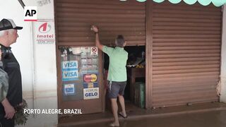 Shopkeepers in Brazil's flood-hit south try to save goods as forecast to worsen.