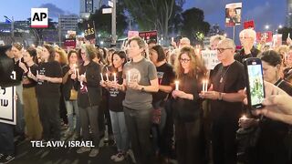 Sirens sound and relatives of hostages light candles in Tel Aviv as Israel marks Memorial Day.