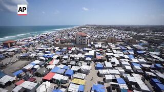 Tents crowd Mediterranean shore of Deir al-Balah as more Palestinian displaced arrive.