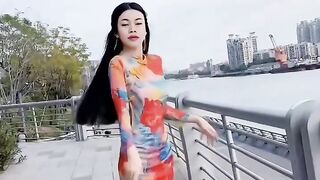 我穿着中国旗袍在江边行走
