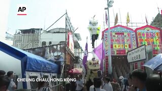 Crowds cram tiny island for Hong Kong's traditional bun festival.
