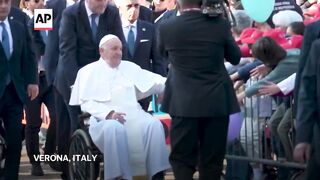 Pope Francis greets crowds in Verona on one-day pastoral journey.