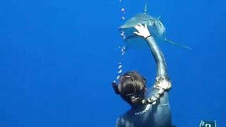 The man play with shart under water